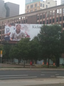 Billboard blocked by a tree.